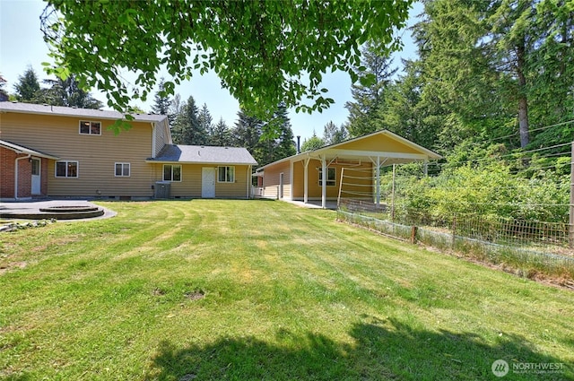 26025 Tronson Rd, Arlington, WA 98223 - view of green lawn featuring central AC unit and a carport