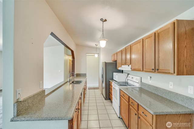 546 Canal Dr NE, Ocean Shores, WA 98569 - kitchen with white appliances, a sink, a peninsula, under cabinet range hood, and light stone counters