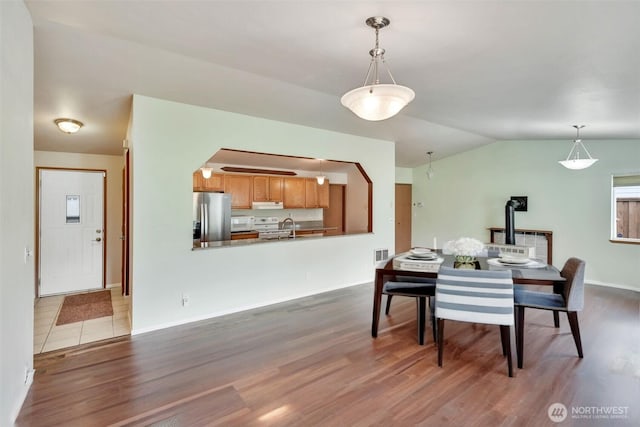 546 Canal Dr NE, Ocean Shores, WA 98569 - dining room with dark wood-style floors, vaulted ceiling, and arched walkways