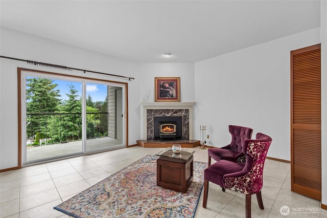 17440 NE 38th St Unit A302, Redmond, WA 98052 - living room featuring light tile patterned floors, a premium fireplace, and baseboards