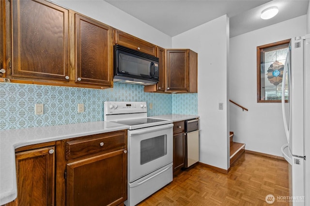 17440 NE 38th St Unit A302, Redmond, WA 98052 - kitchen featuring white appliances, light countertops, tasteful backsplash, and baseboards
