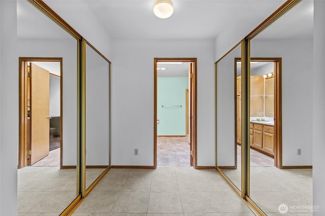 17440 NE 38th St Unit A302, Redmond, WA 98052 - hallway with light tile patterned floors and baseboards