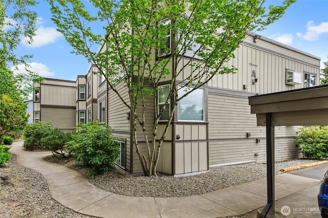 17440 NE 38th St Unit A302, Redmond, WA 98052 - view of home's exterior featuring board and batten siding and a patio area