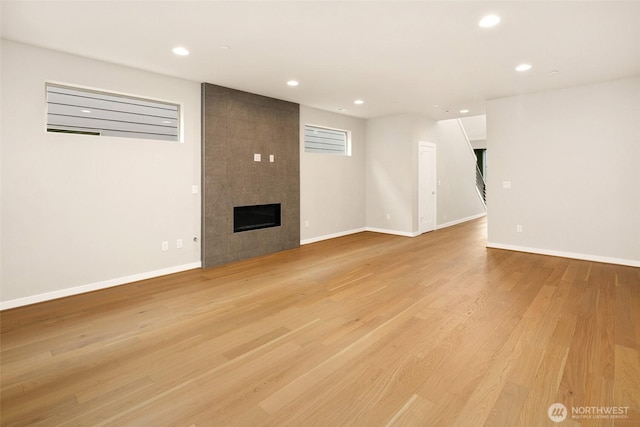 8116 131st Pl SE Unit 16, Snohomish, WA 98296 - unfurnished living room with a tile fireplace, recessed lighting, light wood-type flooring, and baseboards