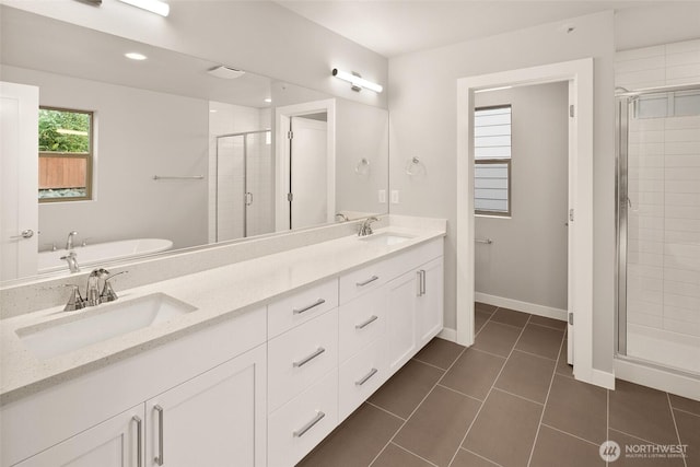 8116 131st Pl SE Unit 16, Snohomish, WA 98296 - full bathroom featuring a stall shower, double vanity, a tub, tile patterned flooring, and baseboards