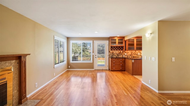 1931 237th St SE, Bothell, WA 98021 - unfurnished living room with a tiled fireplace, light wood-type flooring, and recessed lighting