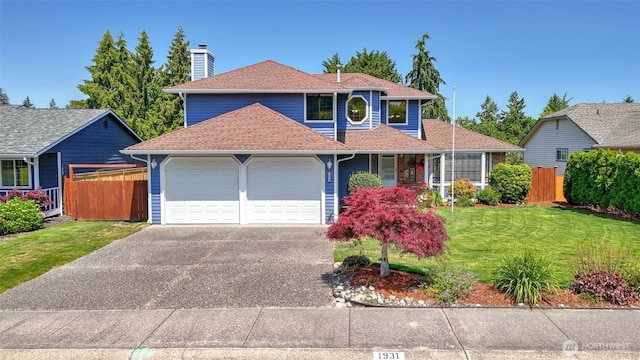 1931 237th St SE, Bothell, WA 98021 - traditional-style house with an attached garage, a chimney, driveway, and roof with shingles