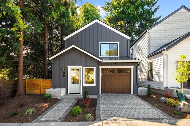 5613 43rd Ave NE, Seattle, WA 98105 - view of front of home with board and batten siding, decorative driveway, and an attached garage