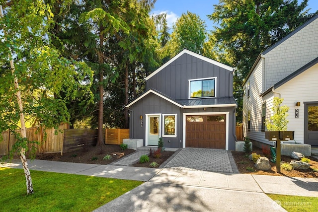 5613 43rd Ave NE, Seattle, WA 98105 - modern farmhouse style home with board and batten siding, decorative driveway, an attached garage, a standing seam roof, and metal roof
