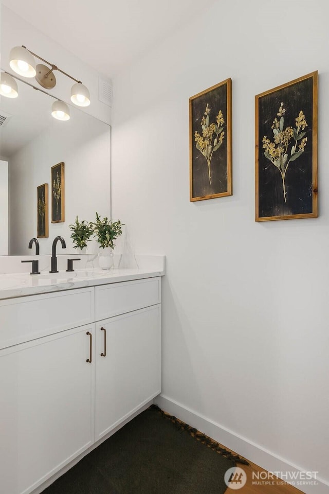 5613 43rd Ave NE, Seattle, WA 98105 - bathroom featuring vanity and baseboards