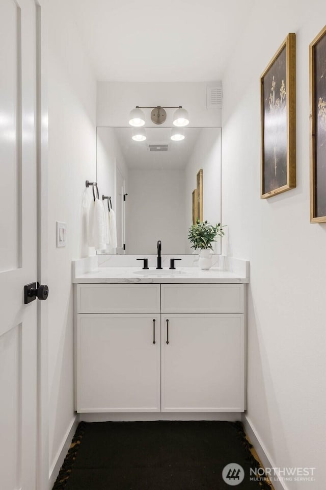 5613 43rd Ave NE, Seattle, WA 98105 - bathroom featuring baseboards and vanity