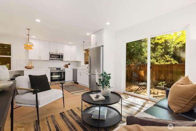 5613 43rd Ave NE, Seattle, WA 98105 - living area featuring light wood-style flooring and recessed lighting