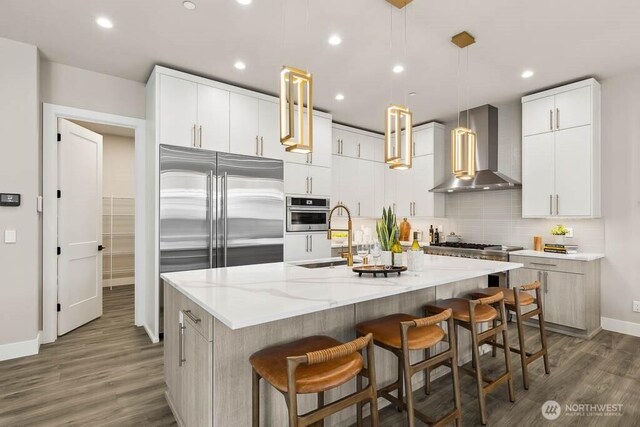 215 8th Ave W, Kirkland, WA 98033 - kitchen with wall chimney range hood, a sink, baseboards, wood finished floors, and tasteful backsplash