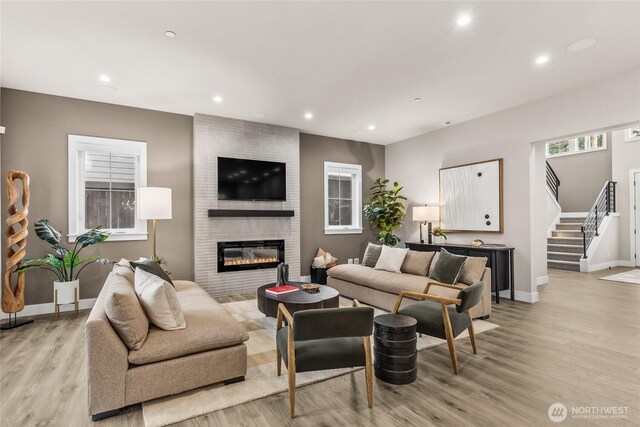 215 8th Ave W, Kirkland, WA 98033 - living room featuring light wood-type flooring, stairway, baseboards, a fireplace, and recessed lighting