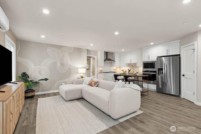 215 8th Ave W, Kirkland, WA 98033 - living area featuring recessed lighting, light wood finished floors, an AC wall unit, and baseboards