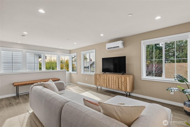 215 8th Ave W, Kirkland, WA 98033 - living room with a wall mounted AC, baseboards, recessed lighting, and light wood-style flooring