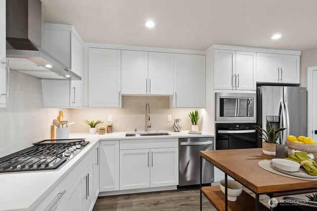 215 8th Ave W, Kirkland, WA 98033 - kitchen featuring stainless steel appliances, a sink, wall chimney range hood, light countertops, and recessed lighting