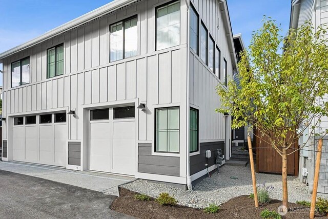 215 8th Ave W, Kirkland, WA 98033 - view of property exterior with board and batten siding and an attached garage