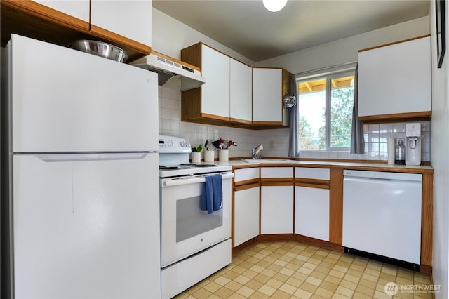 669 Marine Dr, Point Roberts, WA 98281 - kitchen with white appliances, under cabinet range hood, a sink, and backsplash