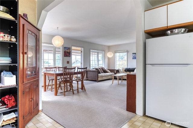 669 Marine Dr, Point Roberts, WA 98281 - kitchen featuring freestanding refrigerator, light colored carpet, pendant lighting, and light flooring