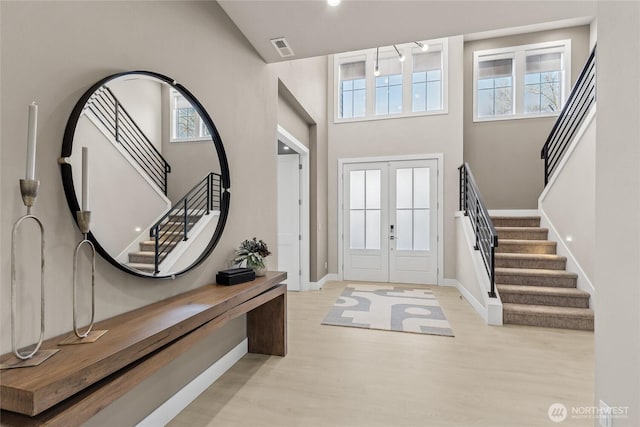 203 8th Ave W, Kirkland, WA 98033 - entryway with stairs, wood finished floors, french doors, high vaulted ceiling, and baseboards