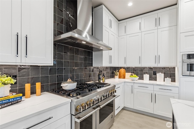 203 8th Ave W, Kirkland, WA 98033 - kitchen with range with two ovens, wall chimney range hood, white cabinets, and light stone counters