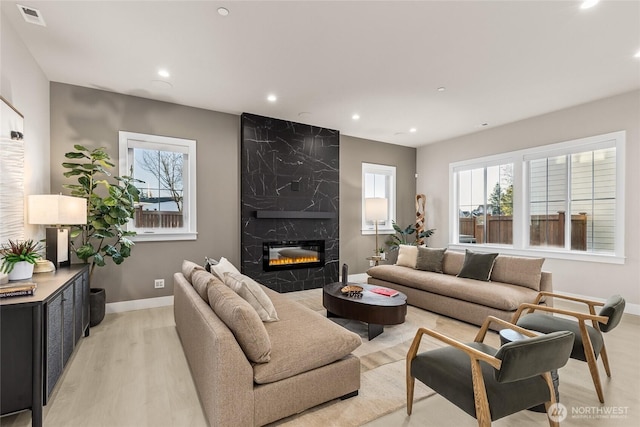 203 8th Ave W, Kirkland, WA 98033 - living room with light wood-style floors, plenty of natural light, recessed lighting, a premium fireplace, and baseboards