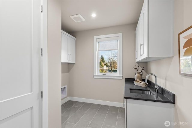 203 8th Ave W, Kirkland, WA 98033 - laundry area with baseboards, light marble finish floors, cabinet space, and recessed lighting