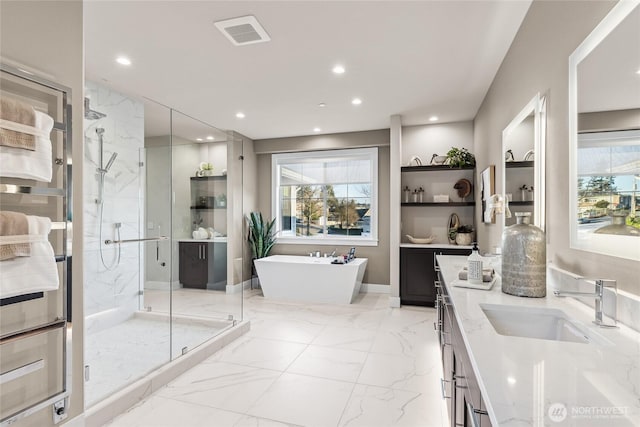 203 8th Ave W, Kirkland, WA 98033 - full bath featuring marble tiled floors, double vanity, a marble finish shower, a soaking tub, and healthy amount of natural light
