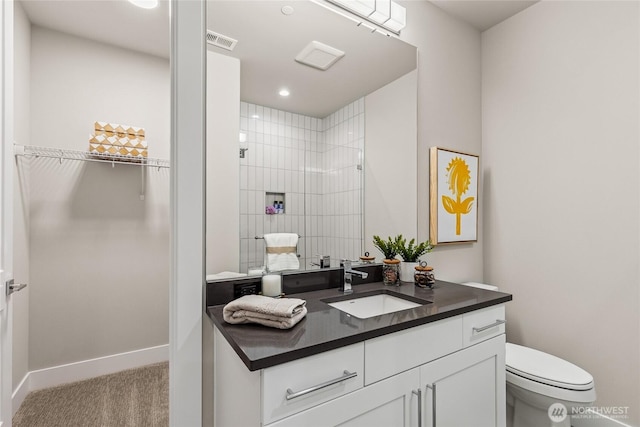 203 8th Ave W, Kirkland, WA 98033 - bathroom with vanity, a walk in closet, toilet, tiled shower, and baseboards