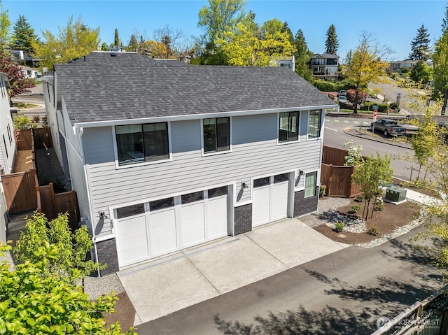 203 8th Ave W, Kirkland, WA 98033 - view of front of house featuring roof with shingles, driveway, and an attached garage