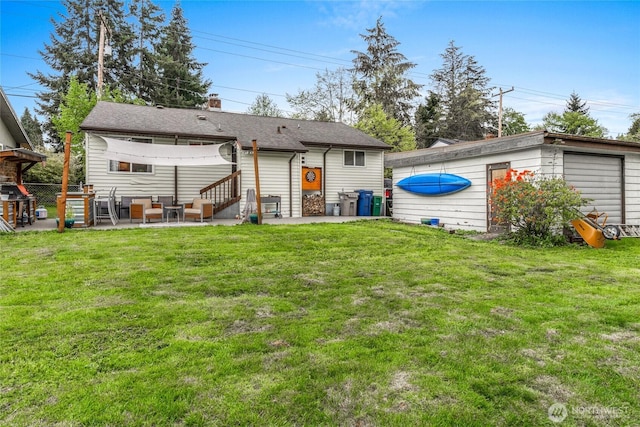 2838 SW 106th St, Seattle, WA 98146 - rear view of property with a patio area, an outdoor hangout area, a detached garage, and a chimney