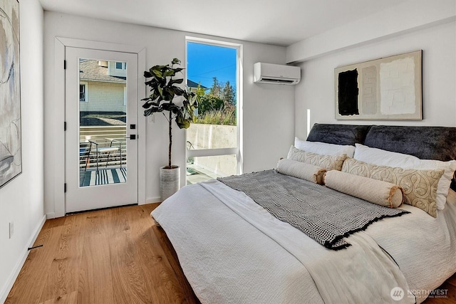 1225 E Roy St, Seattle, WA 98102 - bedroom with a wall mounted AC, access to exterior, multiple windows, and wood finished floors
