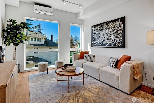 1225 E Roy St, Seattle, WA 98102 - living room with a wall mounted AC, rail lighting, and light wood-style floors