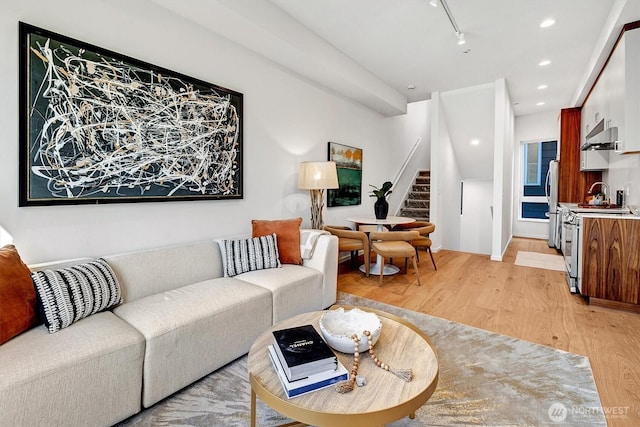 1225 E Roy St, Seattle, WA 98102 - living area with light wood finished floors, stairs, track lighting, and recessed lighting