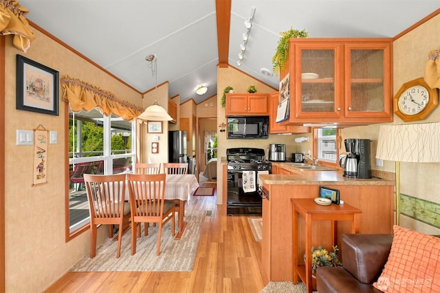 4751 Birch Bay Lynden Rd Unit 32, Blaine, WA 98230 - kitchen featuring black microwave, range with gas cooktop, freestanding refrigerator, light wood-style floors, and vaulted ceiling