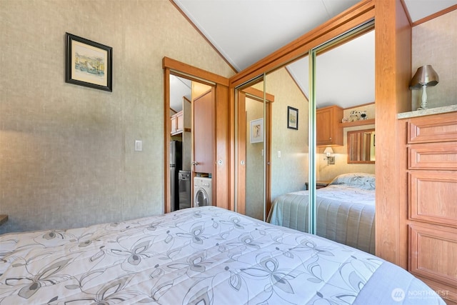 4751 Birch Bay Lynden Rd Unit 32, Blaine, WA 98230 - bedroom featuring lofted ceiling, washer / clothes dryer, freestanding refrigerator, and a closet