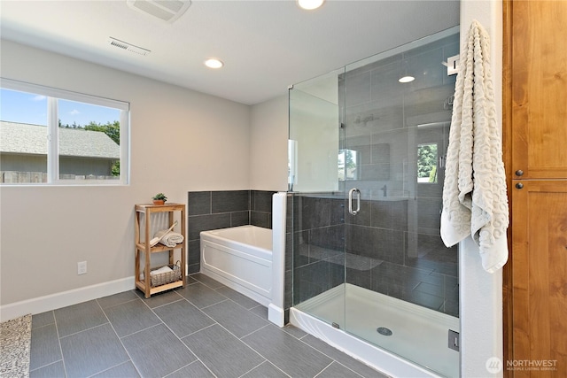 513 I St SW, Tumwater, WA 98512 - bathroom with healthy amount of natural light, a garden tub, a stall shower, baseboards, and recessed lighting
