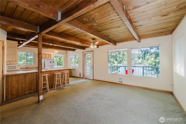 4662 SE Inwood Ln, Port Orchard, WA 98367 - unfurnished living room with wood ceiling with exposed beams, light colored carpet, baseboards, a ceiling fan, and a sink