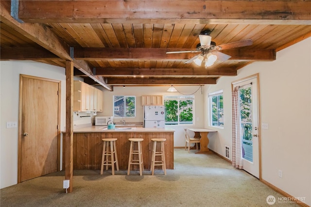 4662 SE Inwood Ln, Port Orchard, WA 98367 - kitchen with white appliances, a peninsula, wooden ceiling with exposed beams, light carpet, and light countertops