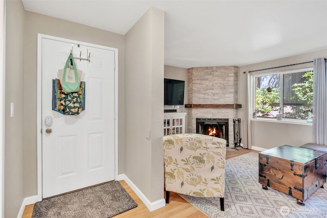 4231 NE 5th St Unit E101, Renton, WA 98059 - foyer entrance with wood finished floors and a fireplace