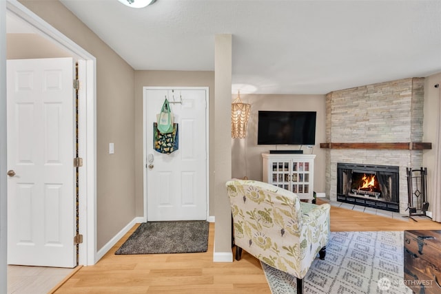 4231 NE 5th St Unit E101, Renton, WA 98059 - entryway featuring wood finished floors and a stone fireplace