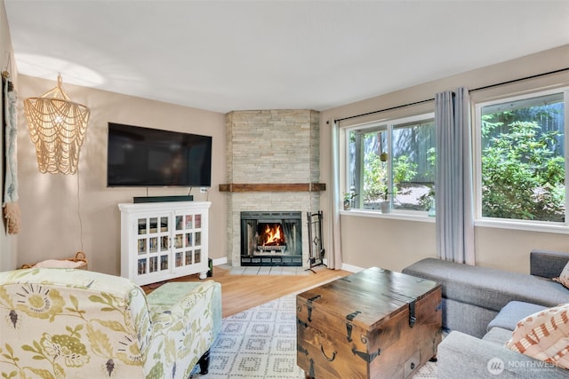 4231 NE 5th St Unit E101, Renton, WA 98059 - living area featuring wood finished floors, a chandelier, and a fireplace
