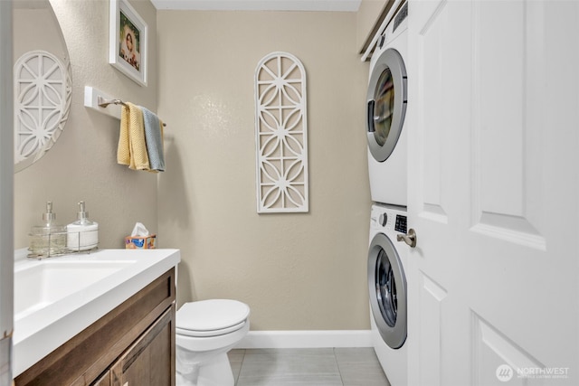4231 NE 5th St Unit E101, Renton, WA 98059 - half bathroom featuring stacked washer / drying machine, vanity, and tile patterned flooring
