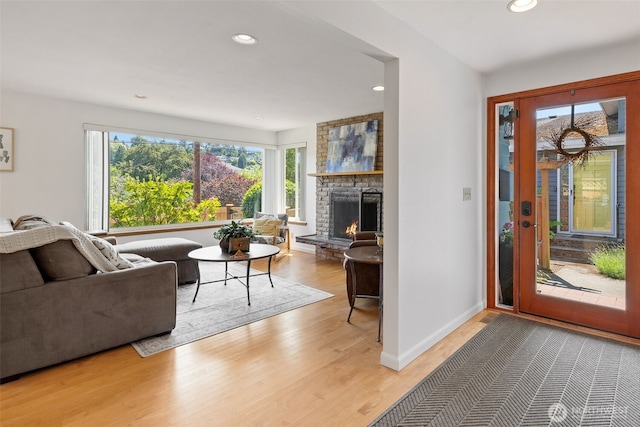 3435 34th Ave W, Seattle, WA 98199 - living room featuring a lit fireplace, light wood-type flooring, recessed lighting, and baseboards