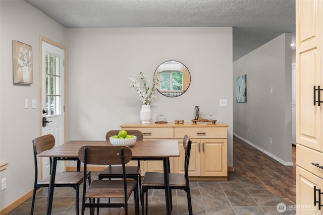 4562 SE Burley Olalla Rd, Olalla, WA 98359 - dining space with baseboards and a textured ceiling