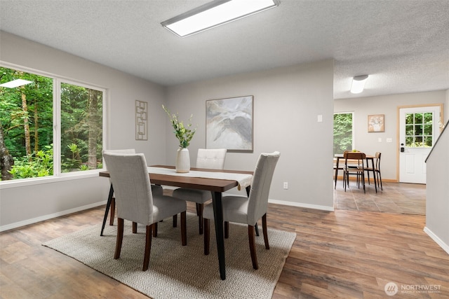4562 SE Burley Olalla Rd, Olalla, WA 98359 - dining room featuring healthy amount of natural light, baseboards, and wood finished floors