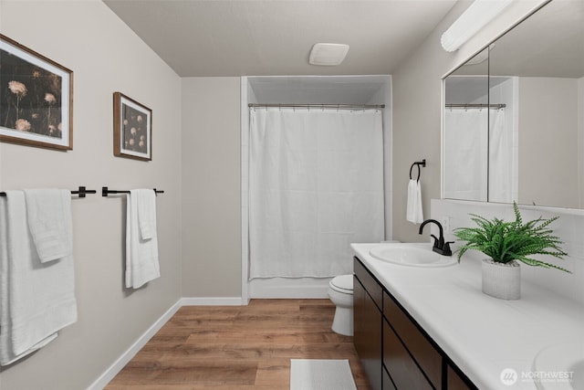 4562 SE Burley Olalla Rd, Olalla, WA 98359 - bathroom featuring double vanity, wood finished floors, toilet, and baseboards