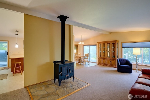 17147 Hope Island Ln, La Conner, WA 98257 - living room featuring carpet flooring, a wood stove, plenty of natural light, and a chandelier