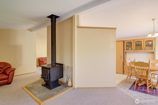 17147 Hope Island Ln, La Conner, WA 98257 - living room featuring light colored carpet, a wood stove, and baseboards